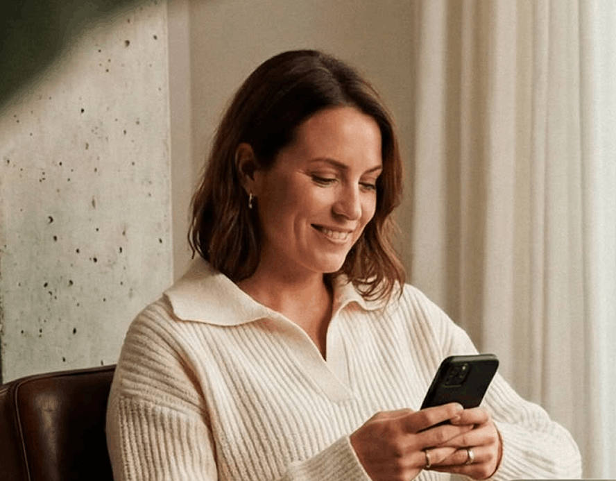 Restaurant guest reading a promotional email on her smartphone