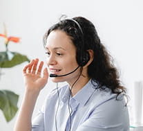 Rezku customer support representative with headset in a welcoming office